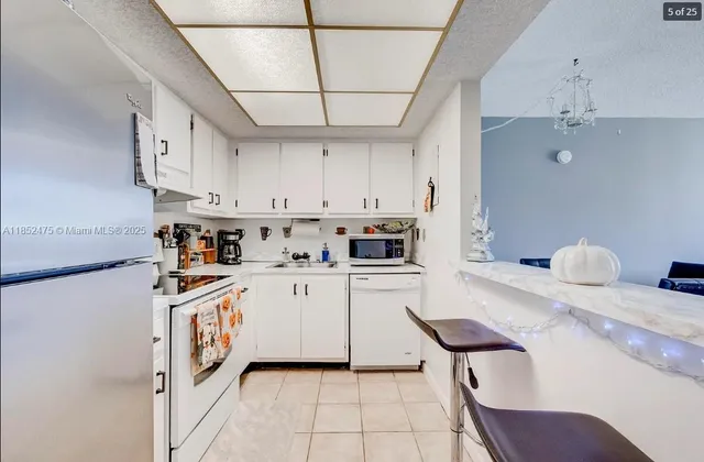 a kitchen with cabinets a sink and appliances
