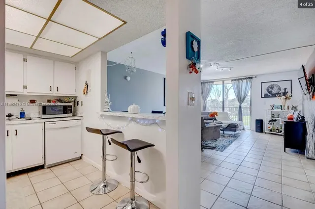 a kitchen with stainless steel appliances kitchen island granite countertop a sink and cabinets