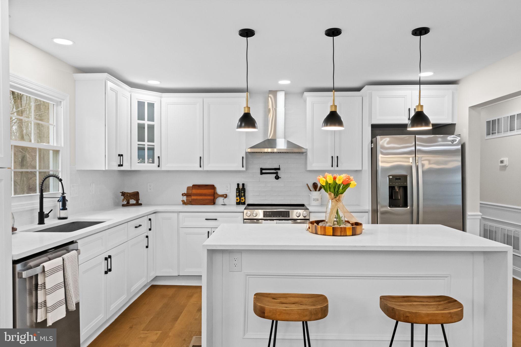 971 Stevens Lane Wayne, PA 19087 - Photo 21 of 66 a kitchen with stainless steel appliances a sink a stove a refrigerator and cabinets