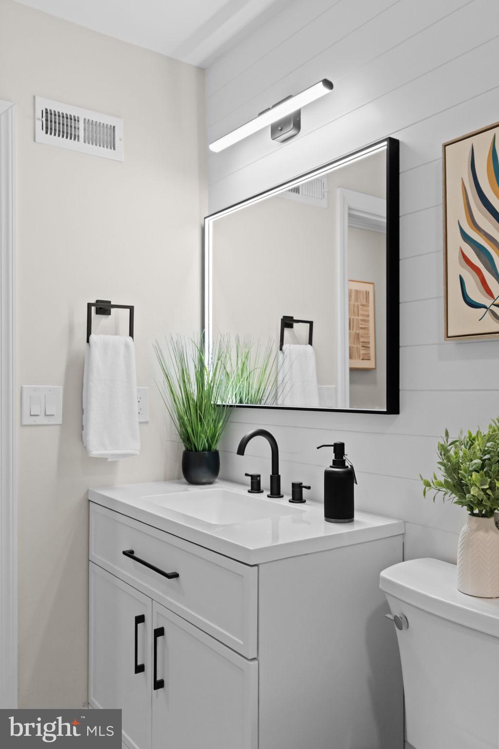 971 Stevens Lane Wayne, PA 19087 - Photo 30 of 66 a bathroom with a sink a toilet and mirror