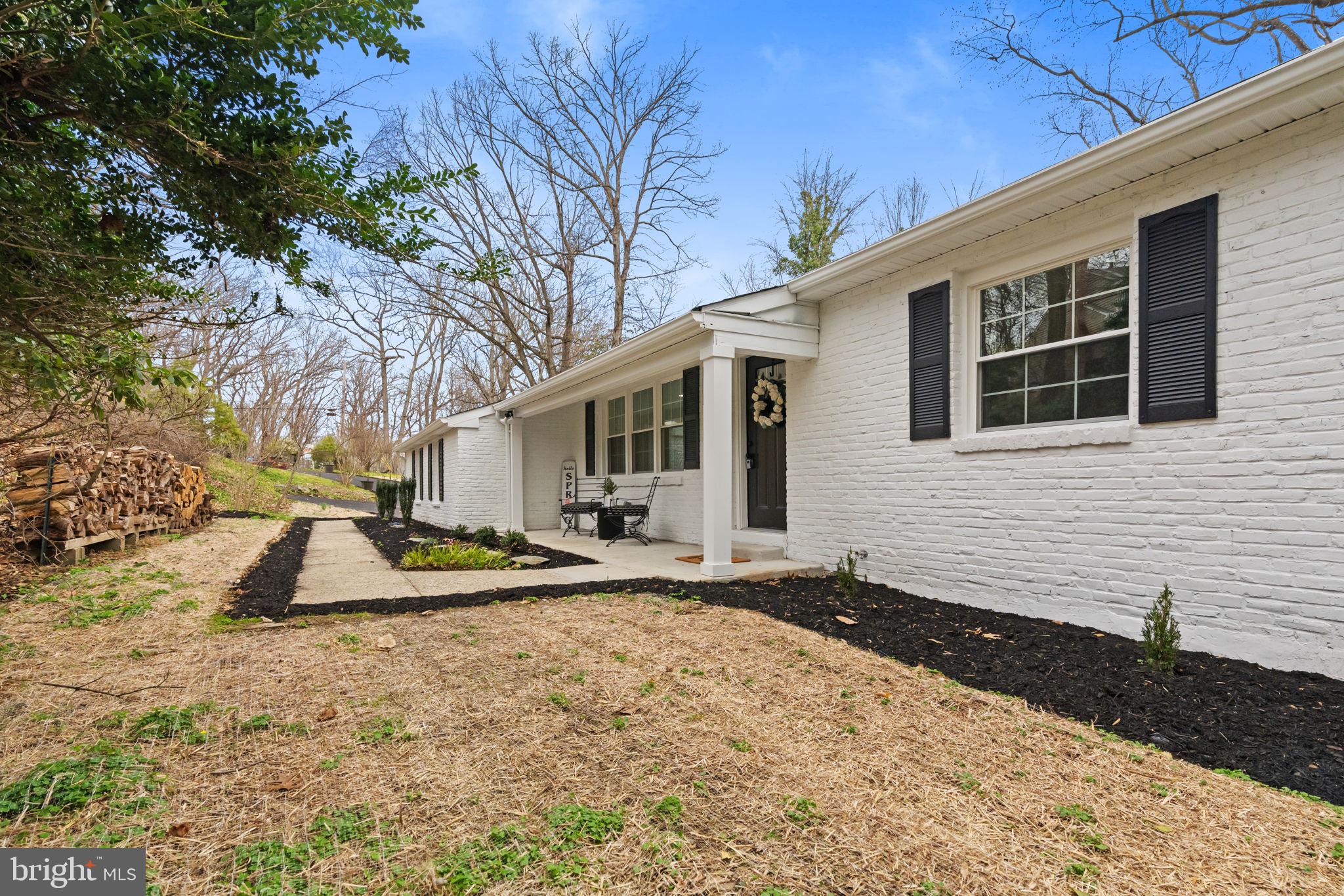 971 Stevens Lane Wayne, PA 19087 - Photo 3 of 66 a backyard of a house with wooden fence and large trees