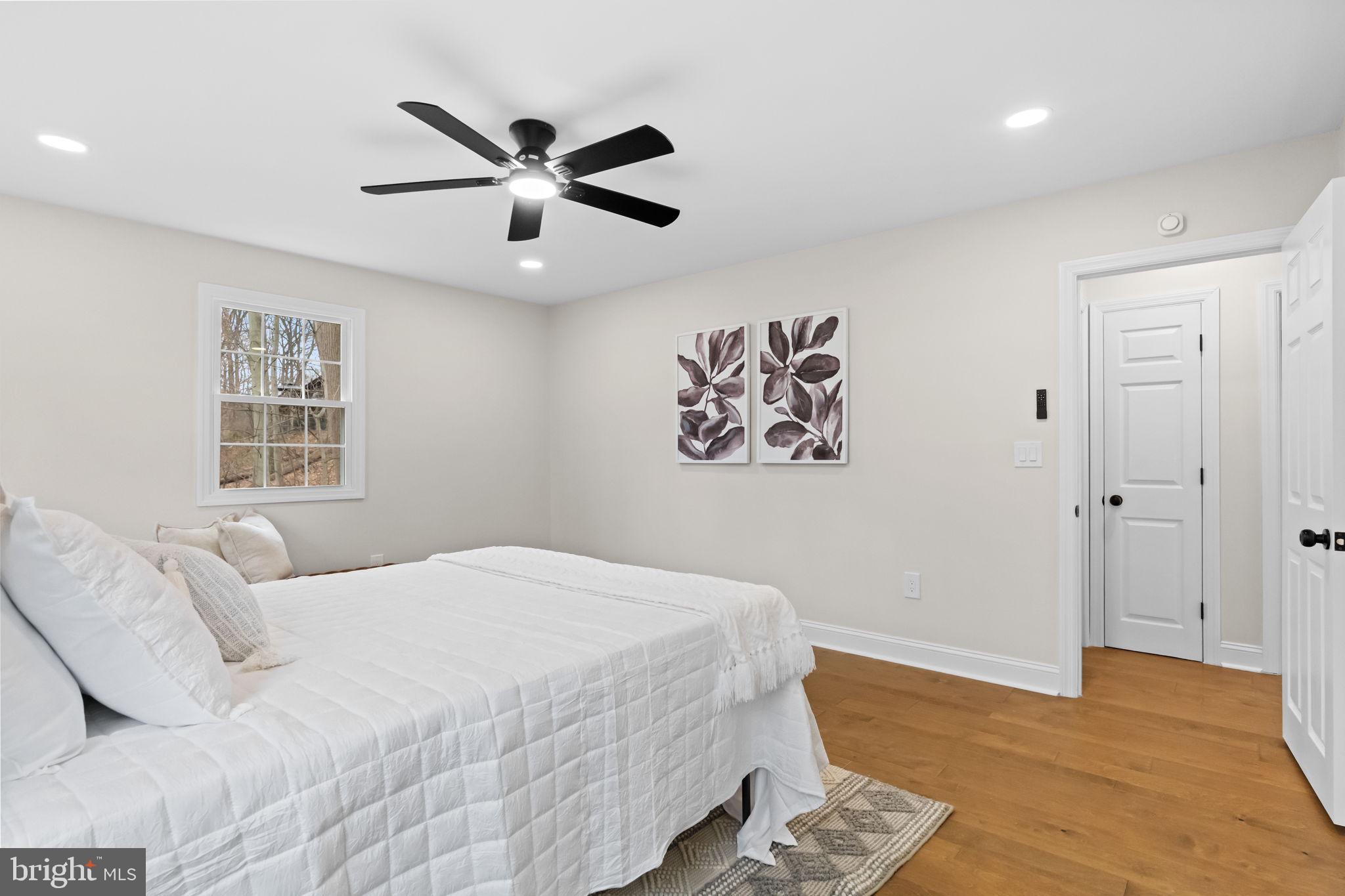 971 Stevens Lane Wayne, PA 19087 - Photo 34 of 66 a bedroom with a bed and a chandelier