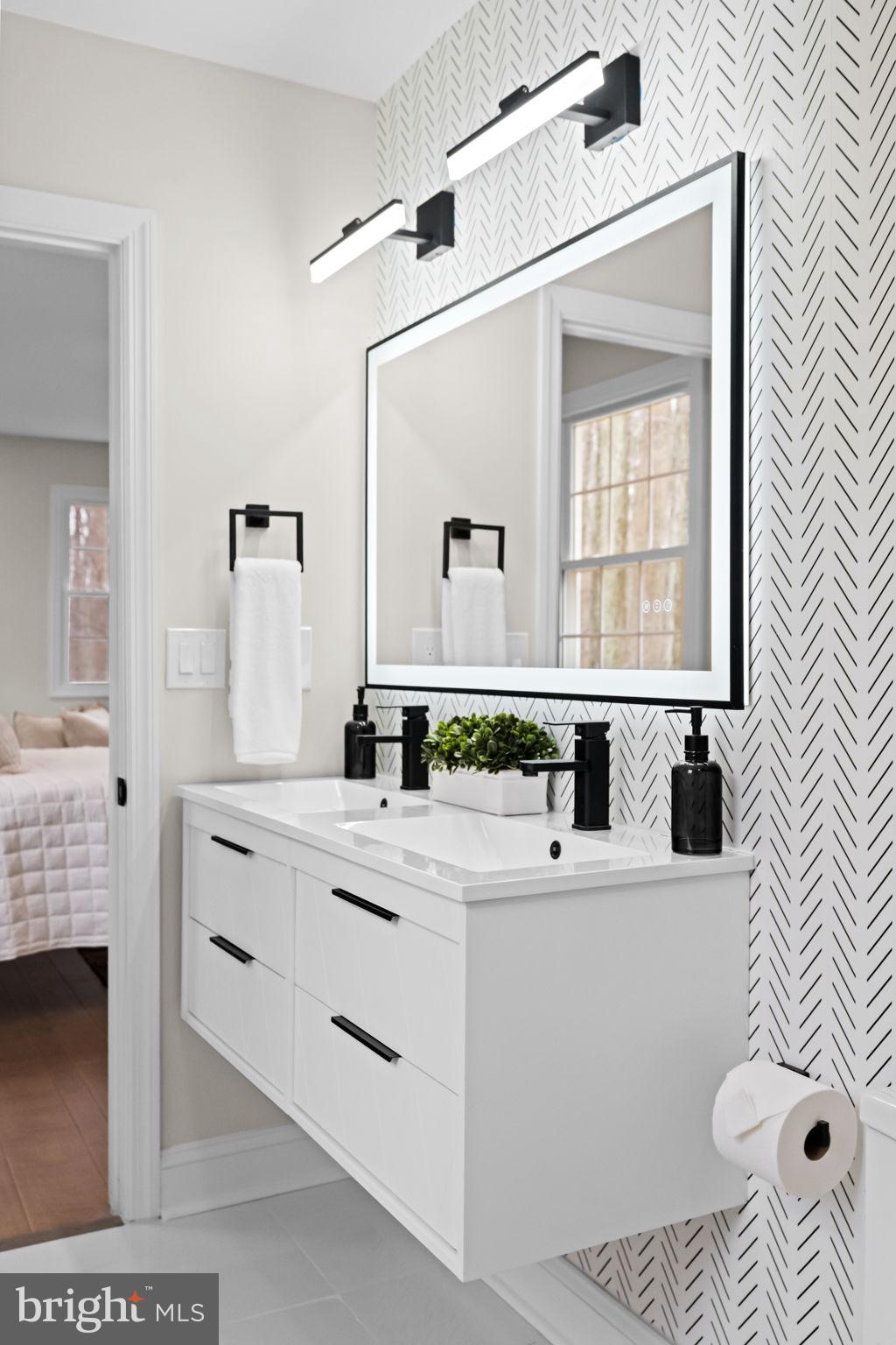 971 Stevens Lane Wayne, PA 19087 - Photo 37 of 66 a bathroom with a sink a toilet and a mirror