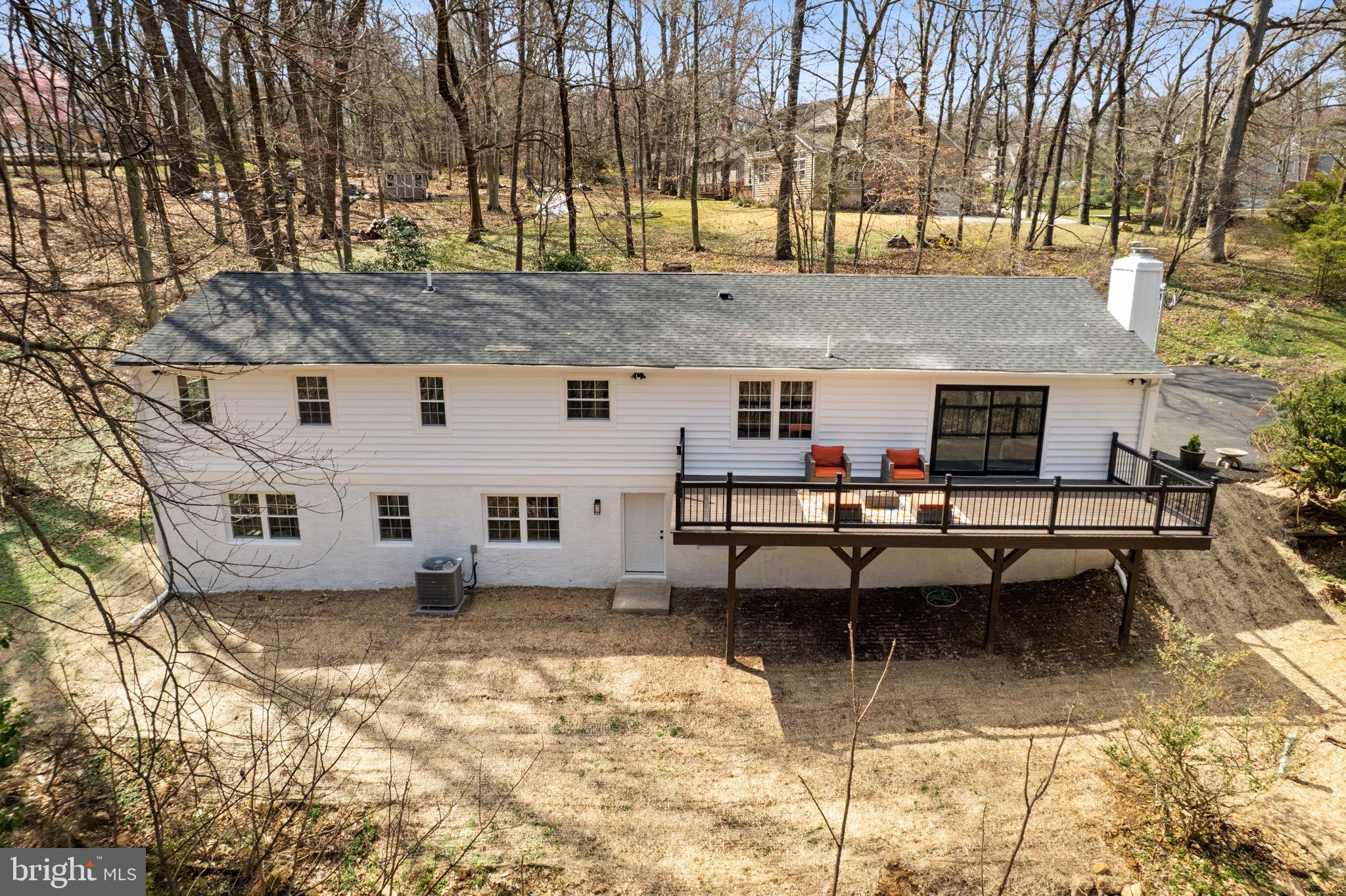 971 Stevens Lane Wayne, PA 19087 - Photo 55 of 66 a view of a patio with table and chairs with wooden fence and floor