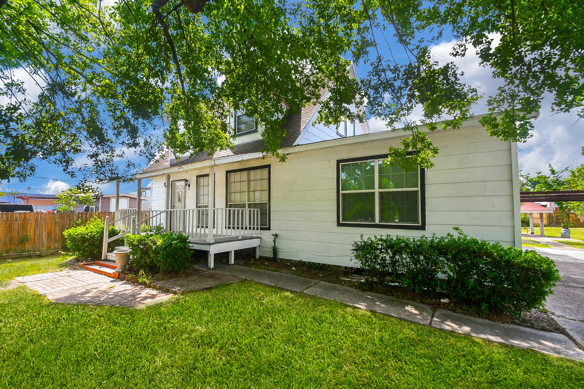 2636 Lone Oak Road Houston, TX 77093 - Photo 2 of 42 Charming home with a cozy front porch and lush greenery. Features a well-maintained lawn and inviting entryway, perfect for enjoying the outdoors.