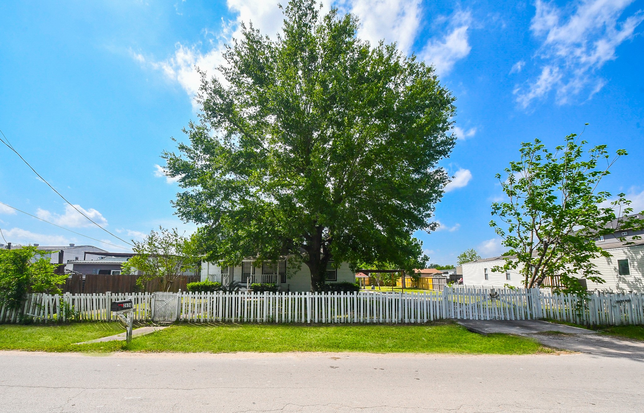 2636 Lone Oak Road Houston, TX 77093 - Photo 10 of 42 Spacious front yard, featuring a large tree providing shade. Ideal for those seeking a welcoming and picturesque setting.
