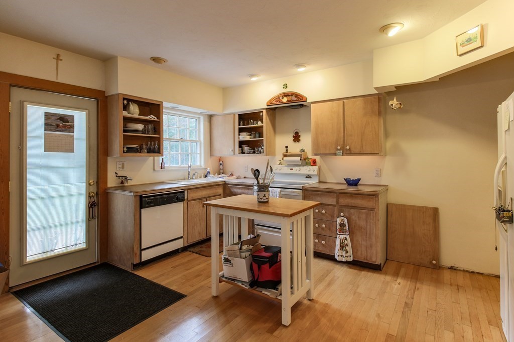 186 Sterling Road Lancaster, MA 01523 - Photo 12 of 40 a kitchen with stainless steel appliances granite countertop a sink stove and refrigerator