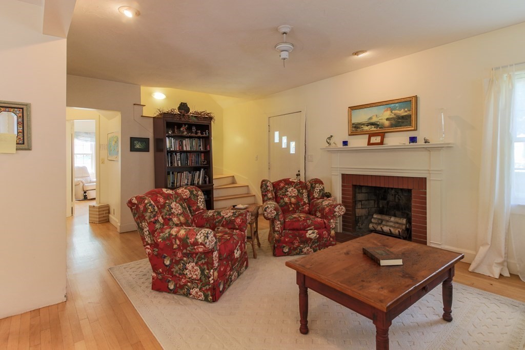 186 Sterling Road Lancaster, MA 01523 - Photo 18 of 40 a living room with furniture a table and a fireplace