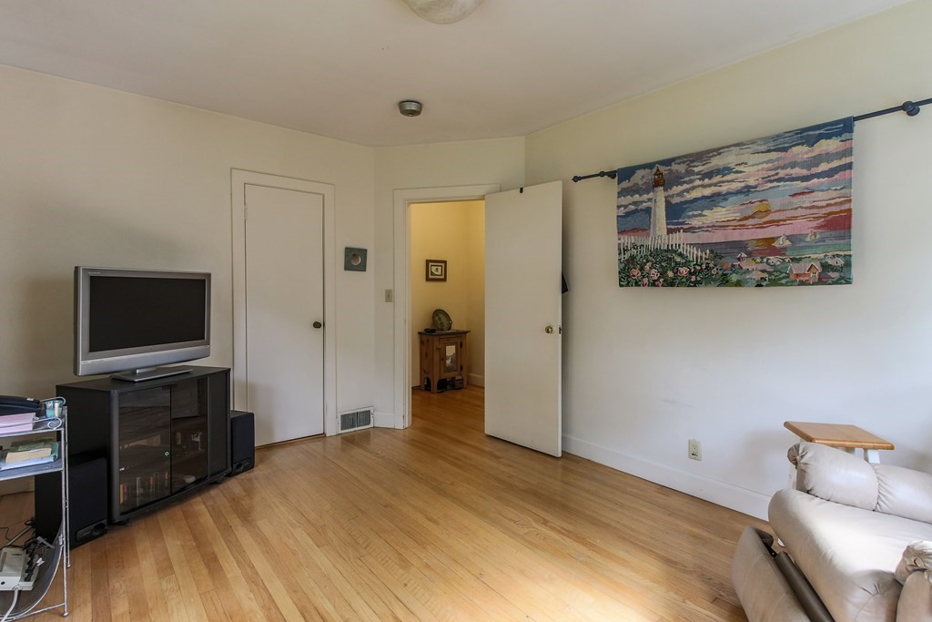 186 Sterling Road Lancaster, MA 01523 - Photo 21 of 40 a bedroom with a bed and a flat screen tv