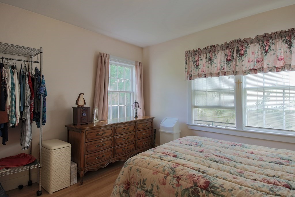 186 Sterling Road Lancaster, MA 01523 - Photo 24 of 40 a bedroom with a bed and wooden floor