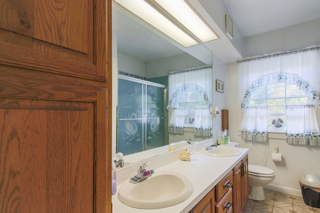 186 Sterling Road Lancaster, MA 01523 - Photo 25 of 40 a bathroom with a sink a toilet and shower