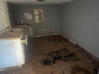 240 South 4th Street Slaton, TX 79364 - Photo 7 of 9 a room with water heater and wooden cabinets