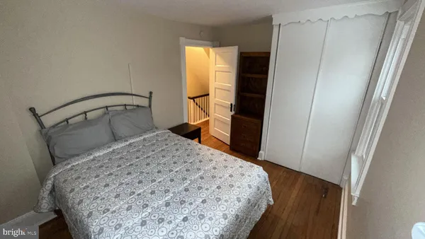 a bedroom with a bed and a dresser in it