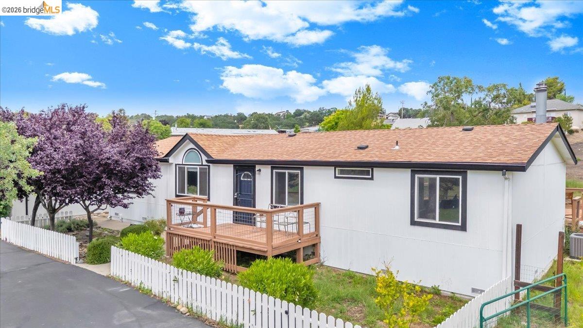 4419 Little John Road Copperopolis, CA 95228 - Photo 37 of 43 White exterior featuring dark trim accents and a wooden deck