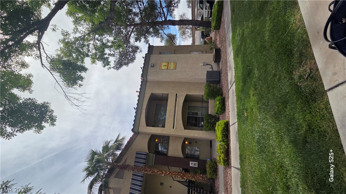 7885 West Flamingo Road, Unit 1008 Las Vegas, NV 89147 - Photo 23 of 29 A well-maintained multi-story building welcomes residents with lush landscaping and shaded balconies.