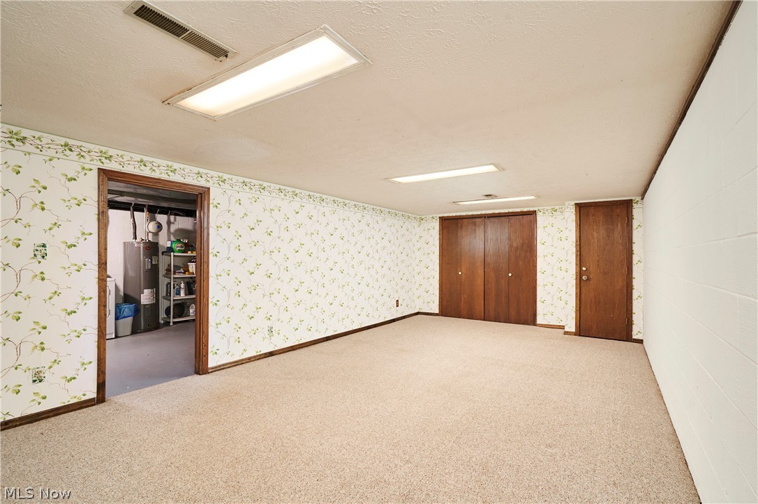 3097 Baughman Road Clinton, OH 44216 - Photo 19 of 27 Carpeted rec room with a full-height ceiling, and recessed lighting