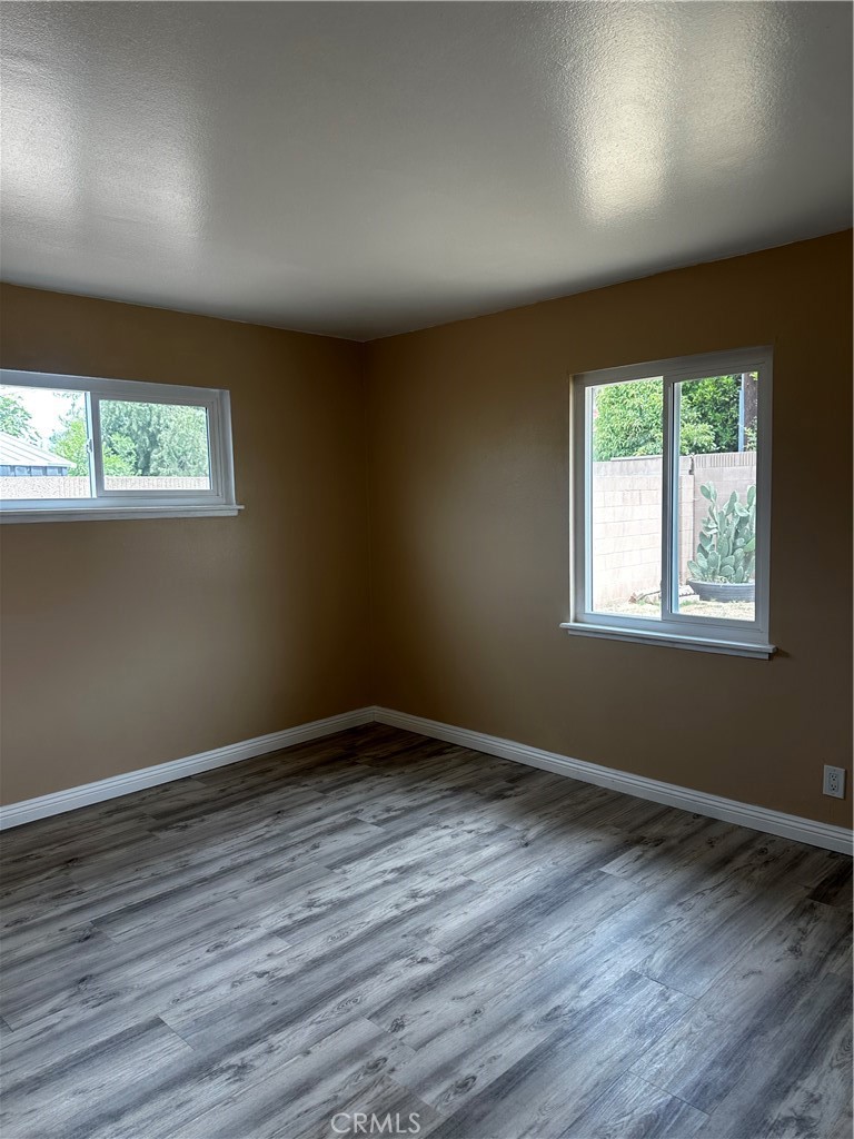 Undisclosed Address La Puente, CA 91746 - Photo 8 of 11 a view of an empty room with wooden floor and a window
