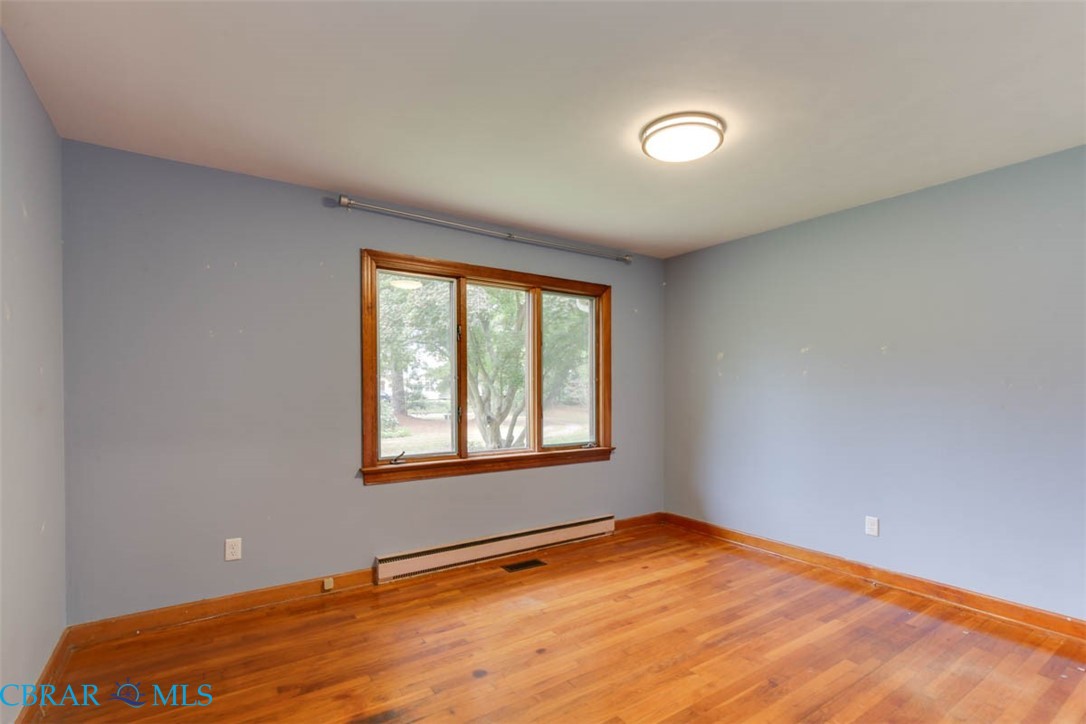 6822 Enfield Road Gloucester, VA 23061 - Photo 28 of 35 Spare room with light wood-type flooring and a baseboard heating unit