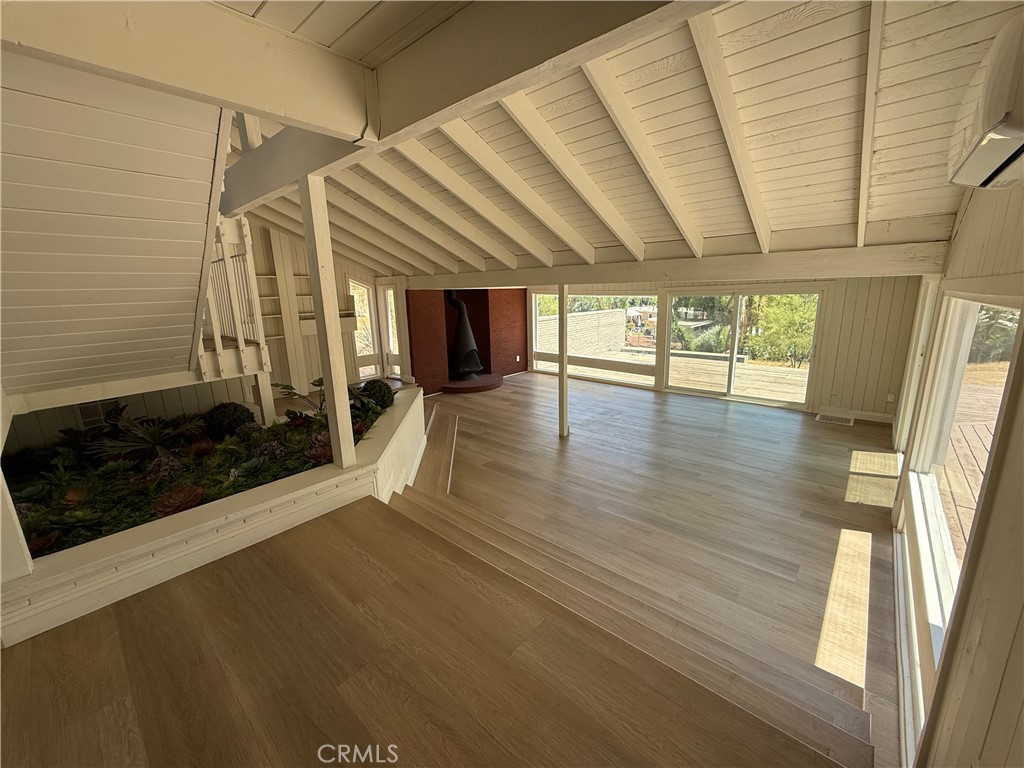 2390 Prenda Avenue Riverside, CA 92504 - Photo 14 of 41 a view of an empty room with wooden floor and a window