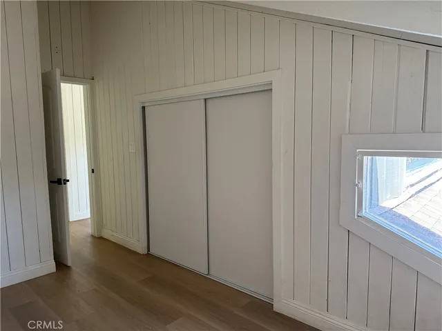 a view of a room with wooden floor and doors