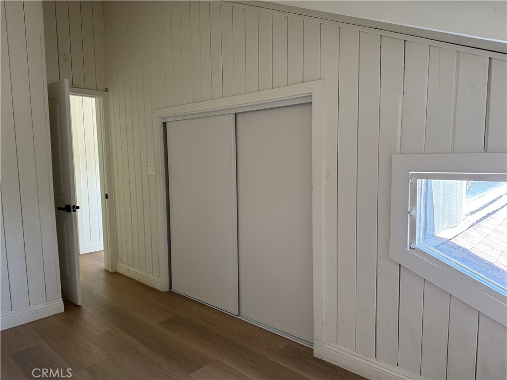 2390 Prenda Avenue Riverside, CA 92504 - Photo 19 of 41 an empty room with wooden floor closet and windows