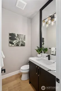 a bathroom with a sink a toilet and mirror