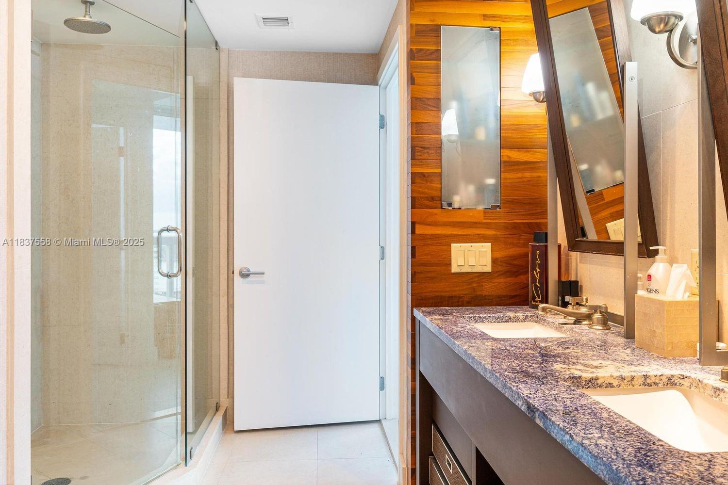 6899 Collins Avenue, Unit 1509 Miami Beach, FL 33141 - Photo 14 of 21 a bathroom with a granite countertop sink and a mirror