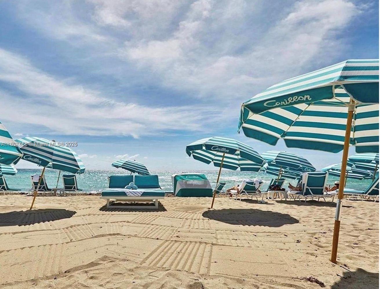 6899 Collins Avenue, Unit 1509 Miami Beach, FL 33141 - Photo 18 of 21 a roof deck with table and chairs