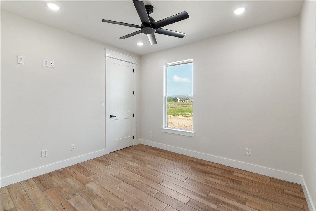 7822 Mathis Crk Drive Bryan, TX 77808 - Photo 28 of 43 an empty room with a window and a ceiling fan