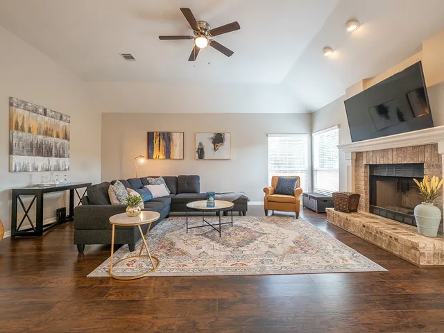 a living room with furniture wooden floor and a fireplace