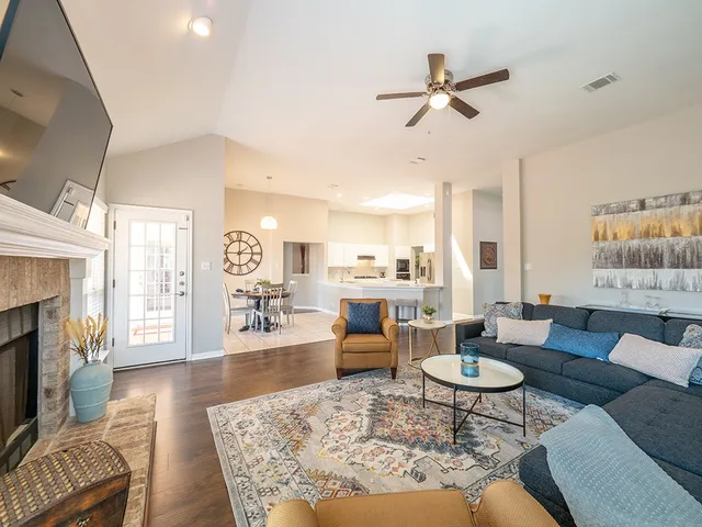 a living room with furniture kitchen view and a fireplace