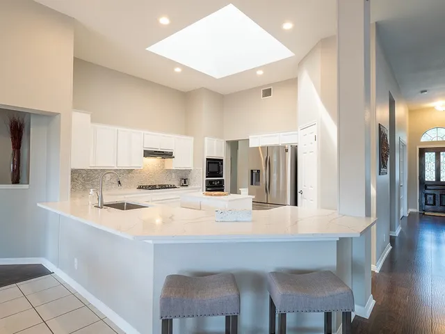 a kitchen with a refrigerator and a stove top oven
