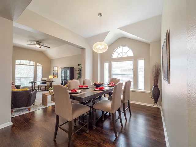 a view of a dining room with furniture and a large window