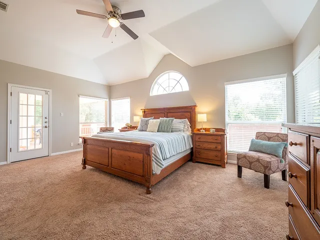a bedroom with a bed and a large window