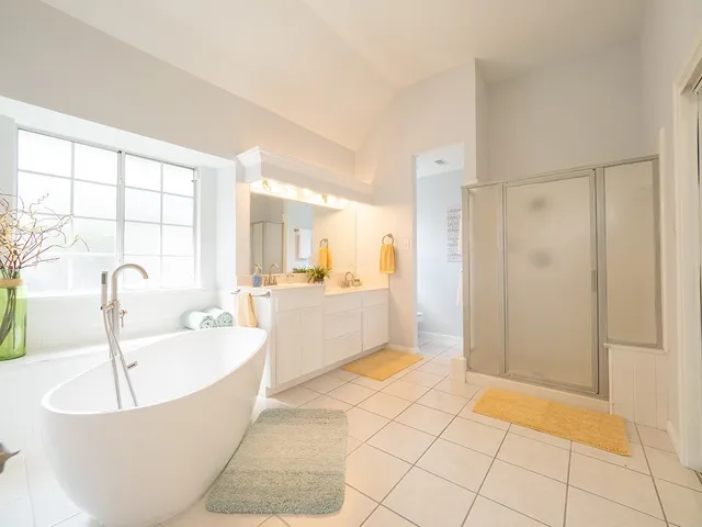 a spacious bedroom with a bed and a large window