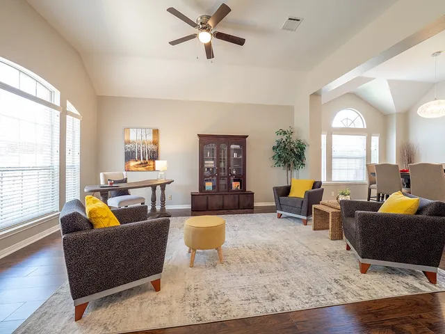 a living room with furniture and a large window