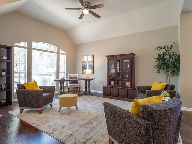 a living room with fireplace furniture and a potted plant