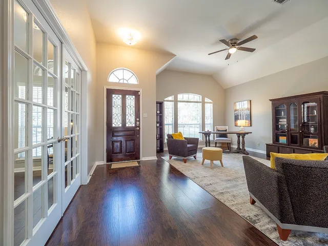 a living room with furniture and a large window