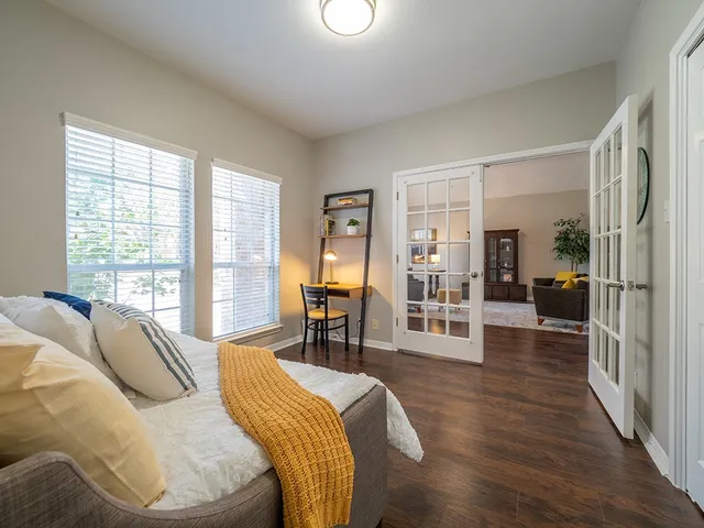 a bed room with a bed and a chair