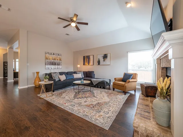 a living room with furniture rug and window