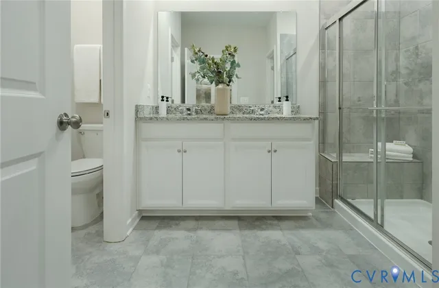 a bathroom with a granite countertop sink and mirror