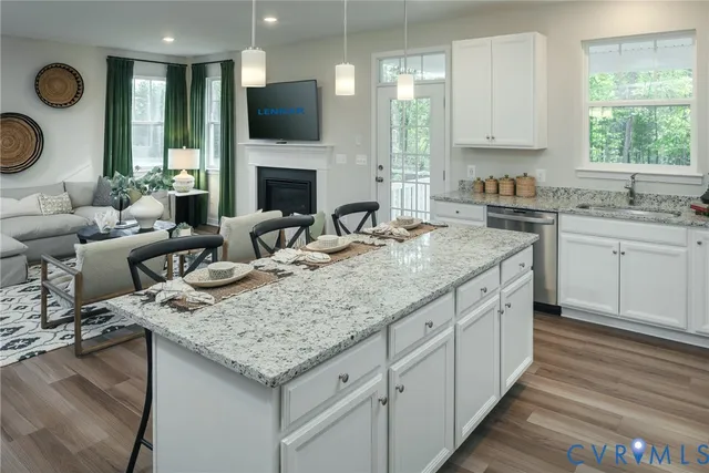 a kitchen with granite countertop lots of counter top space and living room