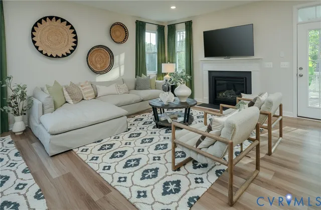 a living room with furniture a flat screen tv and a fireplace