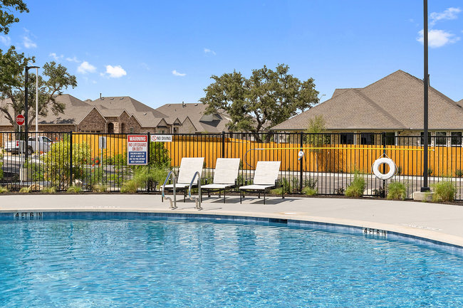 1917 Lazy Acrs Street Leander, TX 78641 - Photo 12 of 20 a view of a lake with a table and chairs