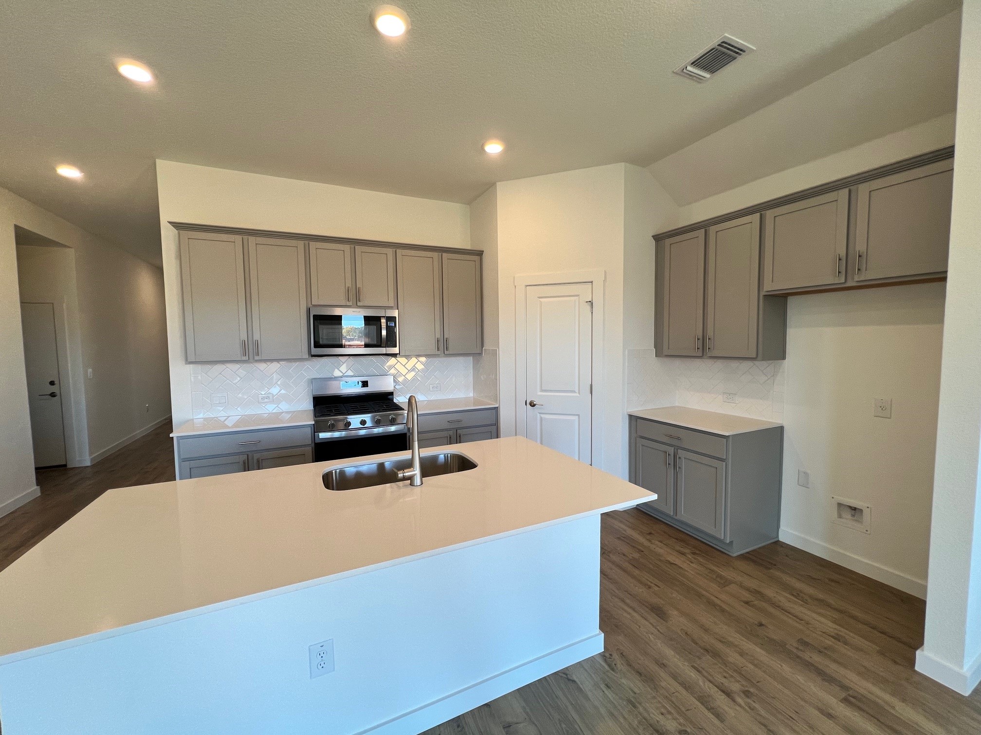 1917 Lazy Acrs Street Leander, TX 78641 - Photo 5 of 20 a kitchen with wooden cabinets and stainless steel appliances