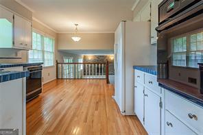 4722 Kenneth Drive Southwest Lilburn, GA 30047 - Photo 5 of 12 a kitchen with stainless steel appliances granite countertop a stove and a refrigerator