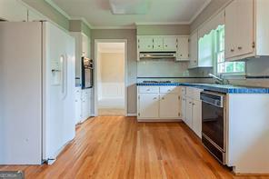 4722 Kenneth Drive Southwest Lilburn, GA 30047 - Photo 6 of 12 a kitchen with stainless steel appliances granite countertop a stove a sink and a refrigerator
