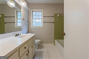4722 Kenneth Drive Southwest Lilburn, GA 30047 - Photo 9 of 12 a bathroom with a sink a toilet and shower