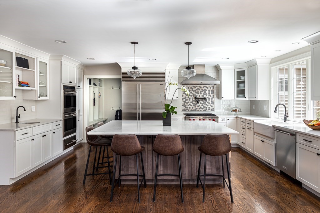 23 Pennock Road Ashland, MA 01721 - Photo 16 of 41 a kitchen with stainless steel appliances a table chairs sink and cabinets