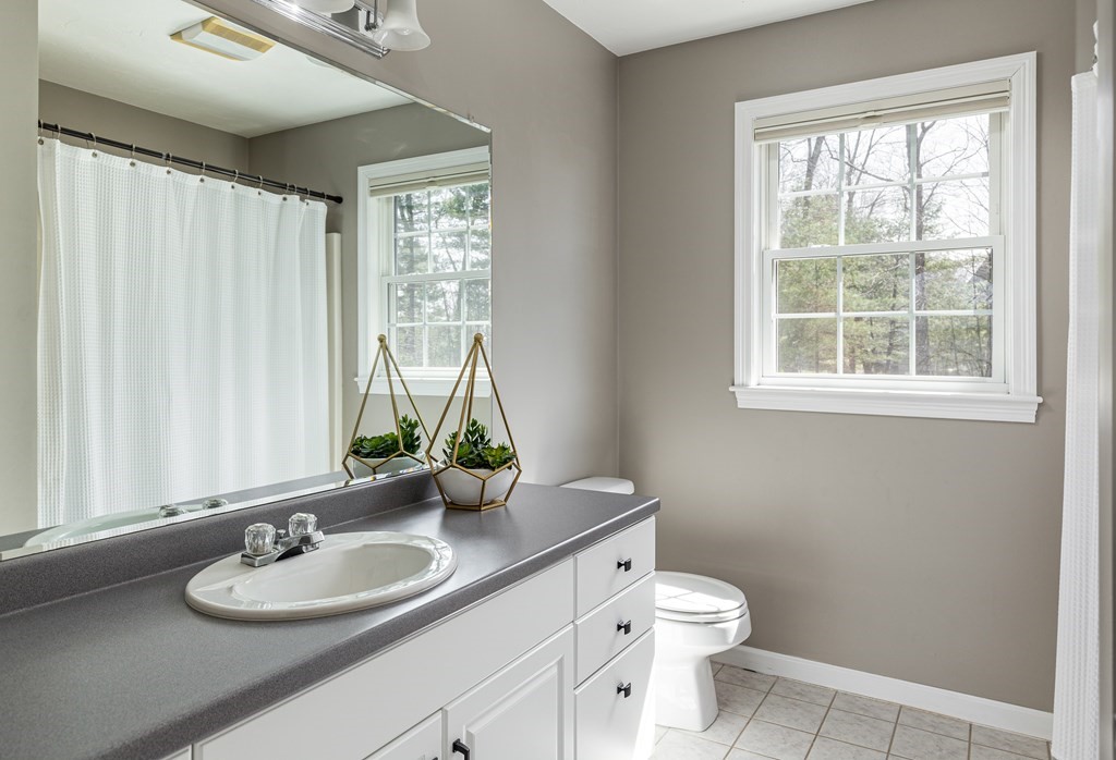 23 Pennock Road Ashland, MA 01721 - Photo 26 of 41 a bathroom with a granite countertop sink toilet and mirror